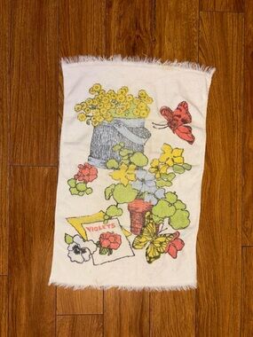 Vintage 1970s hand towel with a floral design and butterflies